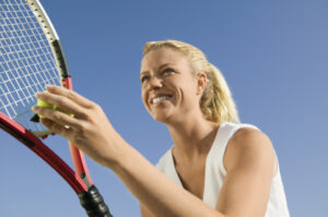 women smiling, playing tennis