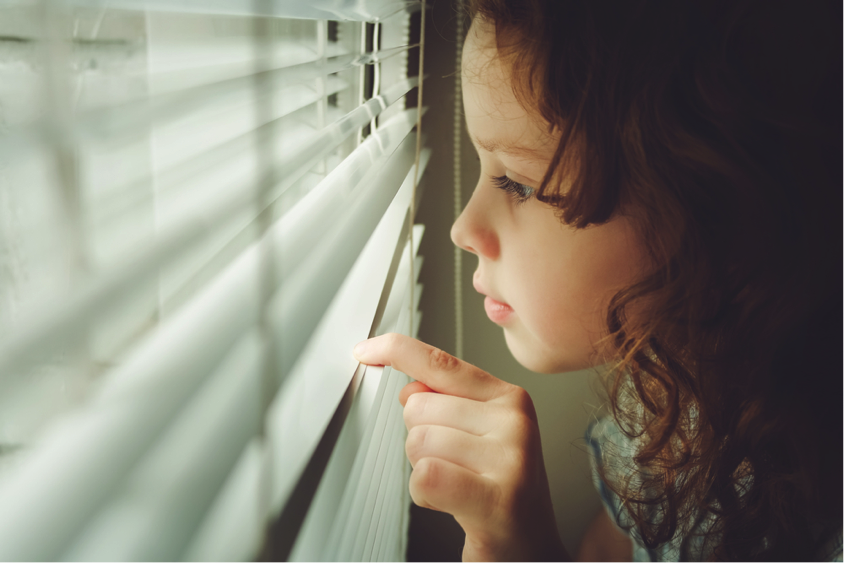 Girl looking out of a window