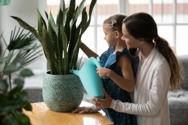 Mother & daughter tending plant