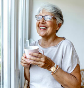Woman happily drinking tea