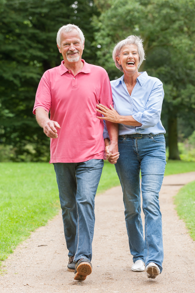 Older couple smiling, walking briskly